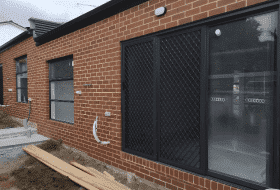 Black sliding door on the side of the house